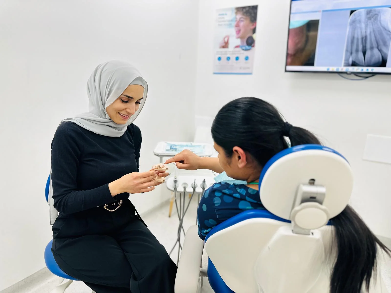 Dr Lina Alnayef discussing dental care with a patient